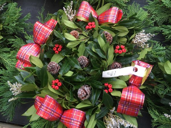 fresh holly wreath berries cones tartan ribbon