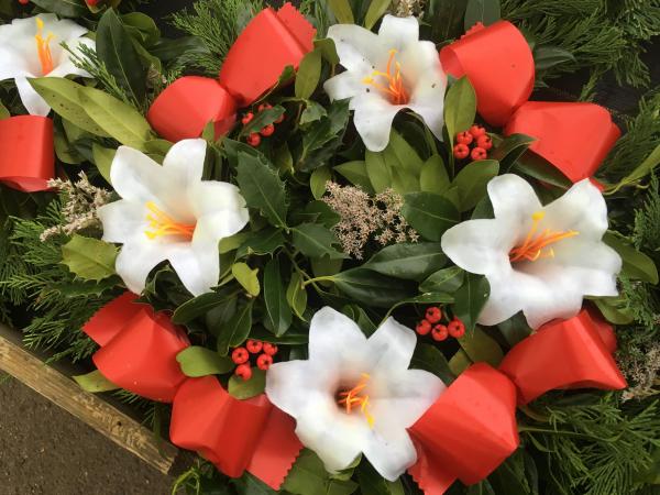 fresh holly wreath white lilies red ribbon