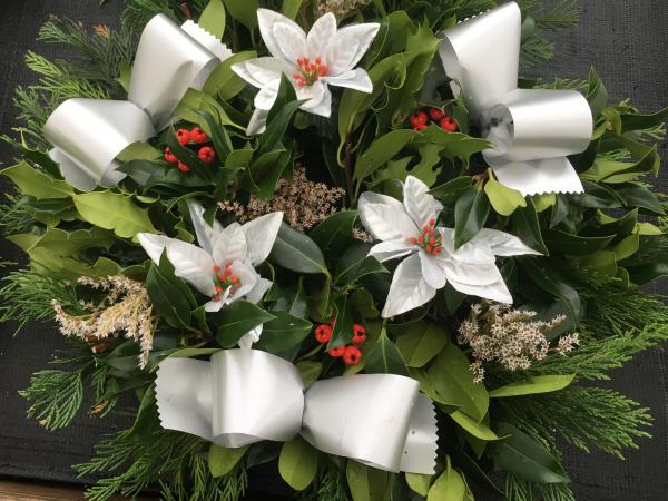 white poinsettia fresh holly wreath yellow white sprigs berries white ribbon